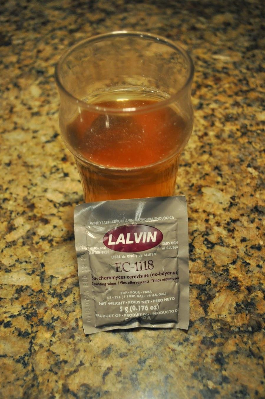 lalvin EC1118 Dry Wine Yeast next to a glass of beer