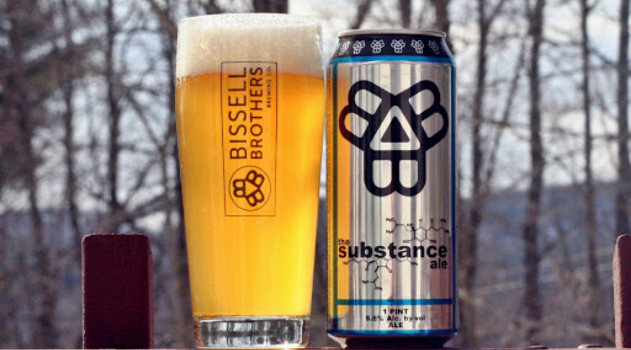 Bissell Brothers The Substance can with full pint next to it in the woods