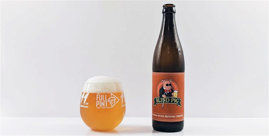 russian river blind pig bottle and full pint glass with white foamy head