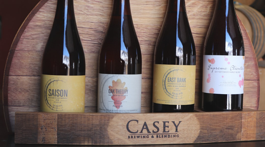 4 different casey brewing and blending beers on a barrel