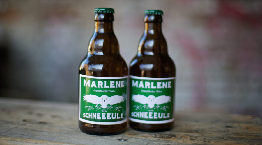 two bottles of scheeeule marlene on a wooden table